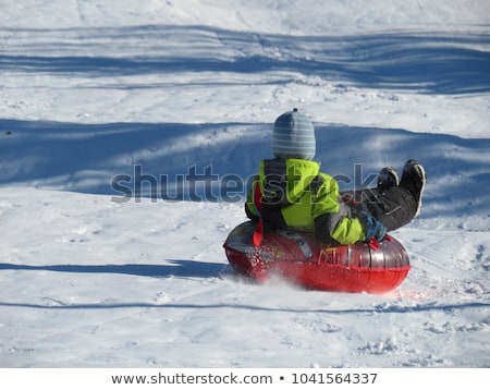 Foto stock: Child Having Fun On Snow Tube Boy Is Riding A Tubing Winter Fun For Children