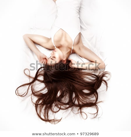 Cute Brunette Lying On White Bed Foto d'archivio © doodko