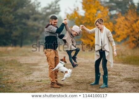 Three People Playing In The Park With Their Dog Imagine de stoc © Stasia04