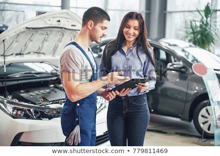 Foto stock: Auto Mechanic And Customer Looking At Car