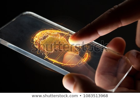 Stok fotoğraf: Hands With Smartphone And Earth Hologram