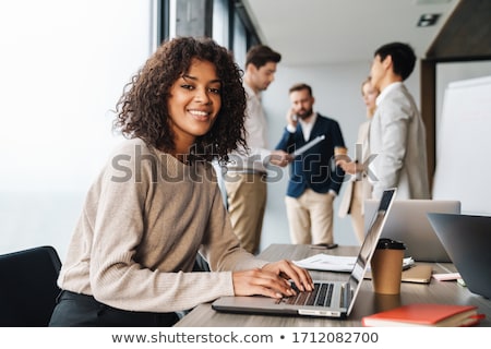 ストックフォト: Beautiful Young Girl In The Office Working At The Computer