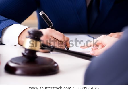 Foto stock: Judge Explaining Document To His Client
