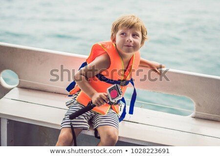 Stock fotó: A Boy On A Ship With An Action Camera Is Ready For Snorkeling