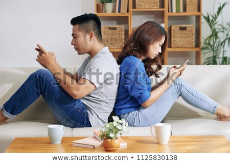 Stock foto: Ethnic Couple Separated With Gadgets