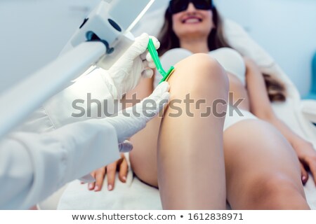 Сток-фото: Therapist Shaving Leg Of Woman Customer Before Starting Hair Removal