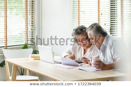 Foto stock: Business Couple With A Laptop And Calculator
