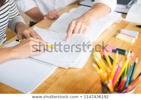 Foto stock: Teacher Helping Students Working At Computers In Classroom