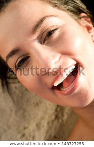 Stock foto: Happy Young Woman Sunbathing In Lounge On Beach