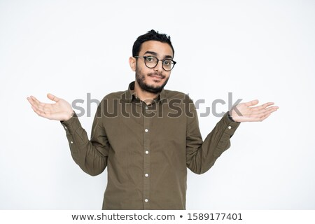 Zdjęcia stock: Young Puzzled Businessman In Eyeglasses Looking At You While Spreading His Hands