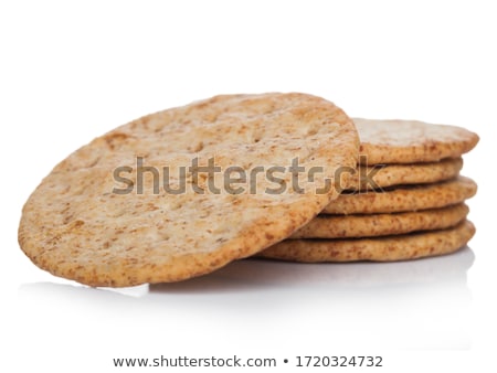 Stok fotoğraf: Stack Of Round Organic Crispy Wheat Flatbread Salty Crackers On White