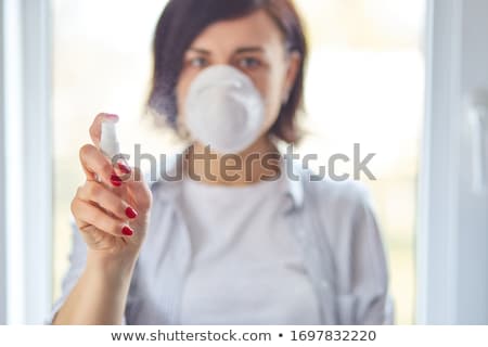 Stok fotoğraf: Womanl Wear Hygienic Mask And Press Alcohol Spray To Protect Sanitizing