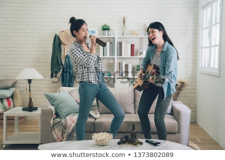Stok fotoğraf: Young Happy Women Have Fun Together Playing Guitar And Dancing Outdoors Near Their Camper Van