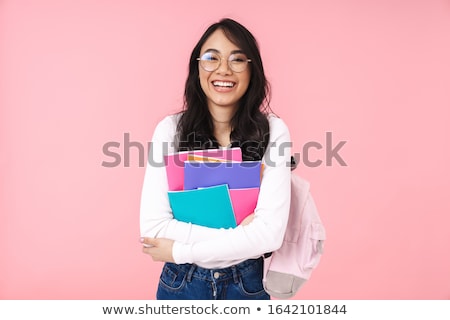 Stok fotoğraf: Portrait Of A Happy Young Brunette Woman Holding Book