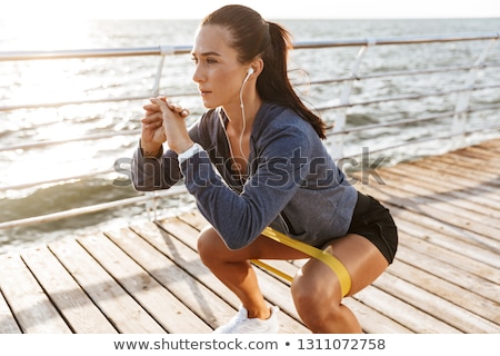 Foto stock: Man Doing Pilates Exercises On Beach In Summer