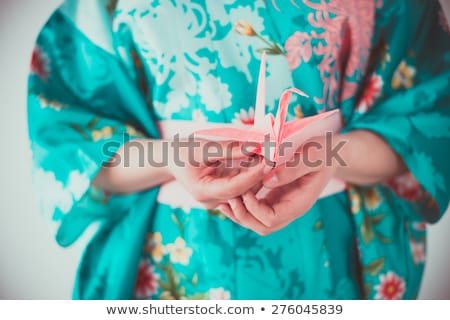 Stockfoto: Beautiful Geisha Holding Origami Bird