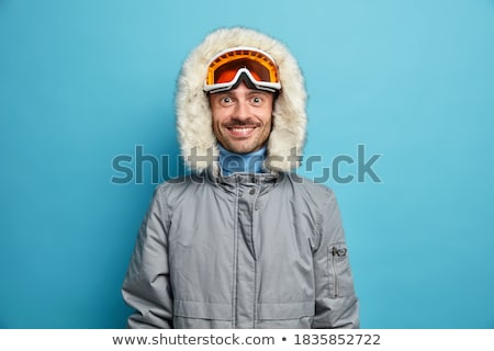 Stock photo: Man Standing In Snow Wearing Warm Clothes On Ski Holiday In Moun