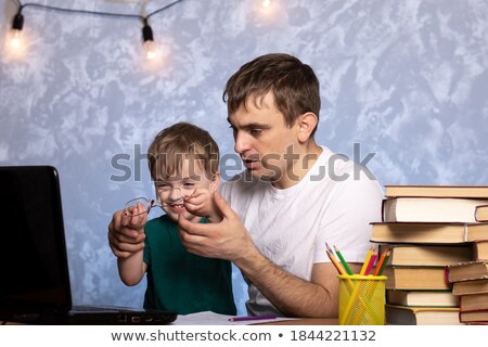 Stockfoto: Family Of Three People Sitting At Table With Laptop On Background Of Sea Daughter Sits On His Lap M