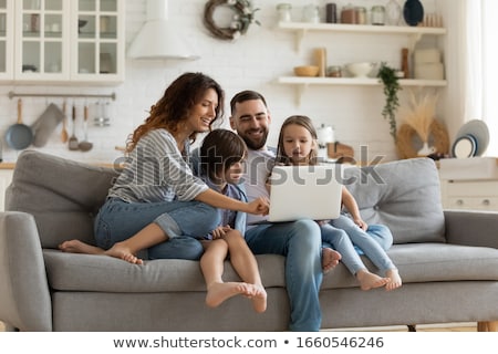 Zdjęcia stock: Mother And Two Girls Looking At Laptop