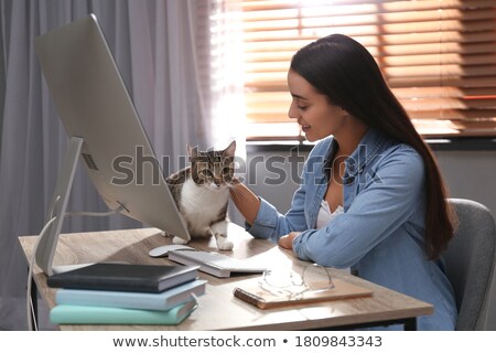 Foto stock: Young Woman Stroking Cat