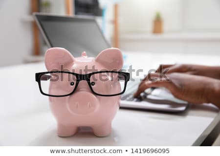 Foto stock: Close Up Of Piggy Bank With Spectacles