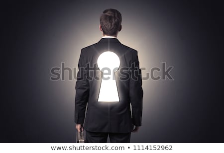 Foto d'archivio: Man Standing With Black Keyhole On His Back