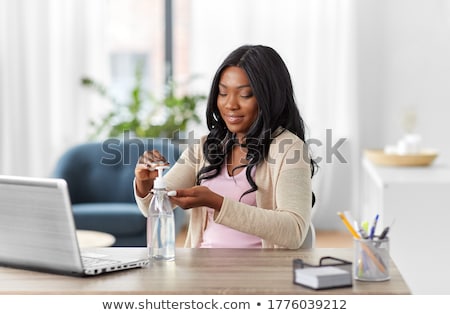 Zdjęcia stock: Black Woman Working From Home Using Hand Sanitizer