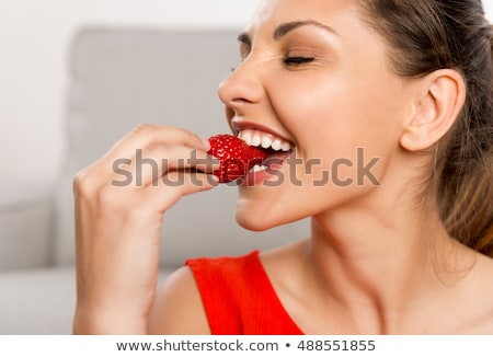 Foto stock: Caucasian Woman Eating A Strawberry