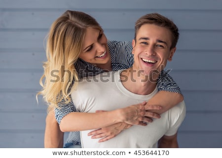 Zdjęcia stock: Young Couple Standing Against The Wall And Hugging