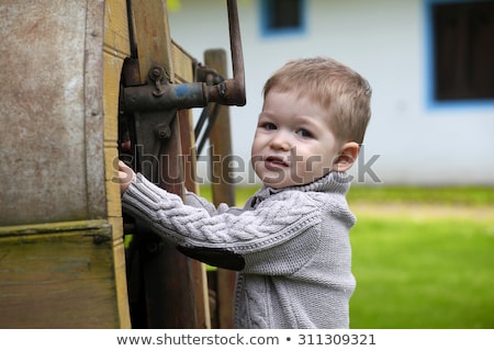 Stok fotoğraf: 2 Years Old Curious Baby Boy Managing With Old Agricultural Mach