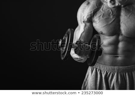 Foto d'archivio: Strong Bodybuilder Flexing His Bicep