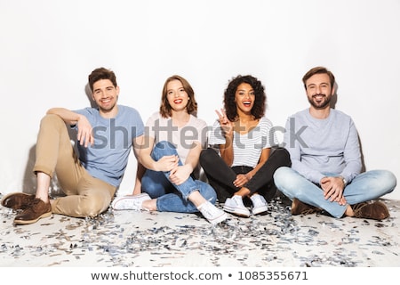 Stok fotoğraf: Group Of Cheerful Multiracial Friends Sitting Isolated