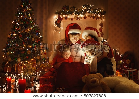 Stockfoto: Happy Family With Christmas Present At Home