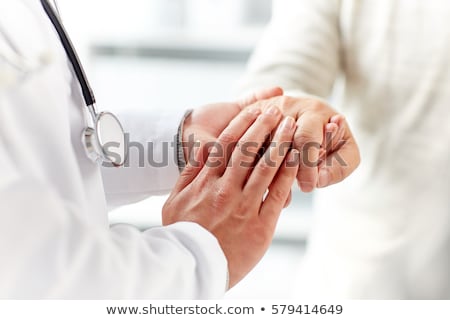 Foto d'archivio: Close Up Of Doctor Holding Senior Patient Hand