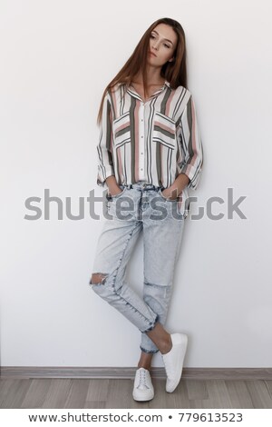 Stock photo: Female With Long Legs Dressed In Ripped Clothes