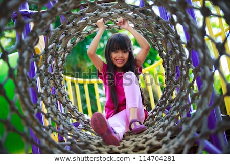 Сток-фото: Young Child Plays On Swing In The Outdoor Playground