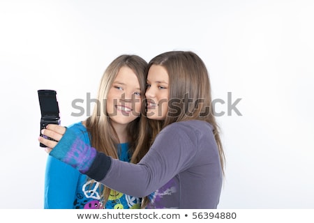 Сток-фото: Beautiful Young Twins Using Mobile Phone