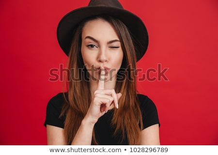 Foto stock: Portrait Of A Pretty Young Girl Showing Silence Gesture