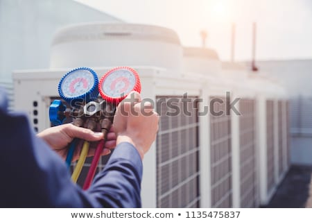 [[stock_photo]]: Electrician Checking Air Conditioner