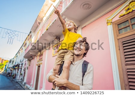 Foto d'archivio: Dad And Son Are Tourists On The Street In The Portugese Style Romani In Phuket Town Also Called Chi