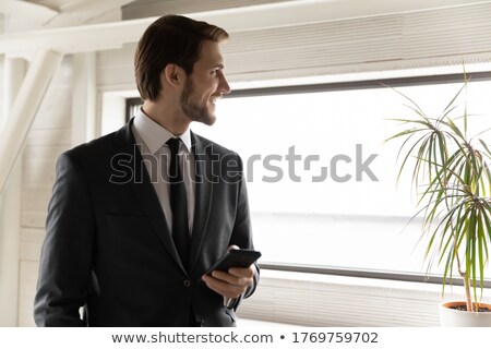 Stockfoto: Pensive Successful Male Employee Focused Into Distnace Holds Magazine Dressed In Formal Clothes W