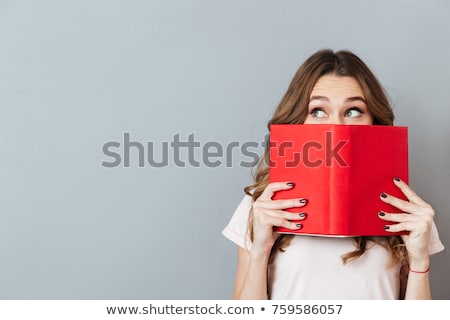 Stock photo: The Girl Hides Behind The Book