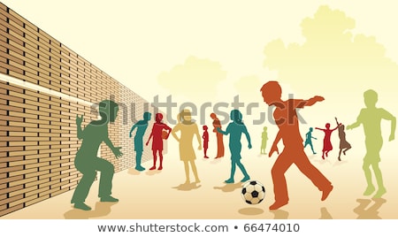 Foto stock: Playing Football At Lunchtime