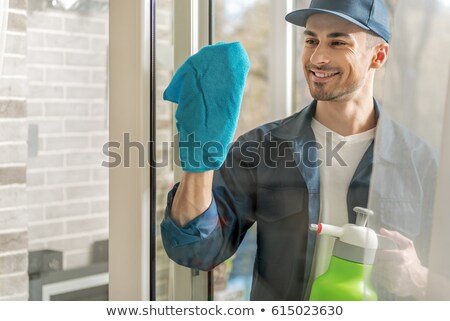 Stockfoto: Man With Cloth Cleaning Window Pane With Detergent Cleaning Con