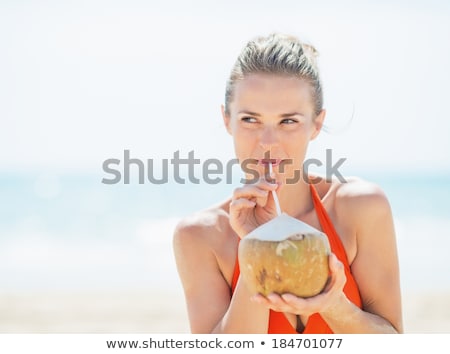 Stock fotó: Young Woman Drinking Coconut Milk On Beach