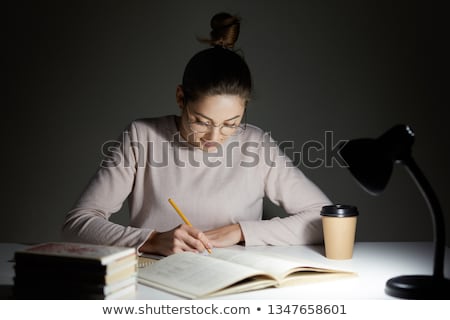 [[stock_photo]]: Young Female Student Preparing For Exams Late At Home