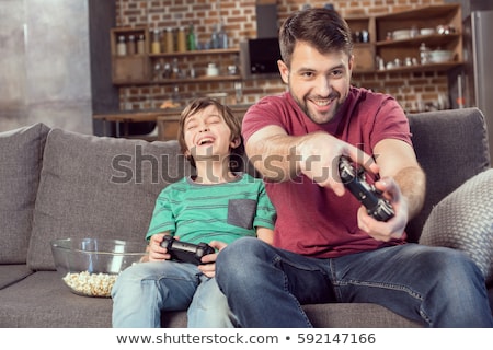 Stockfoto: Father And Son Playing Video Games