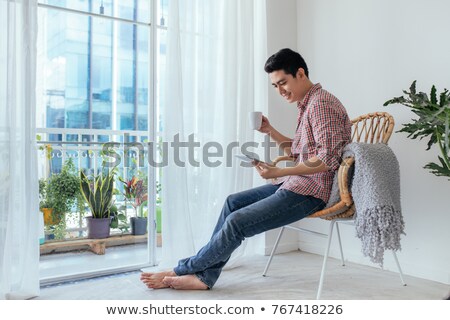 Stok fotoğraf: Man Relaxing At Home With Hot Drink