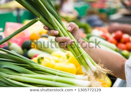 Stock fotó: Woman Buying Bunches Of Spring Onions On Stall At The Market