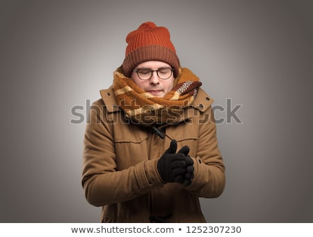 Foto stock: Boy Freezing In Warm Clothing And Snowing Concept